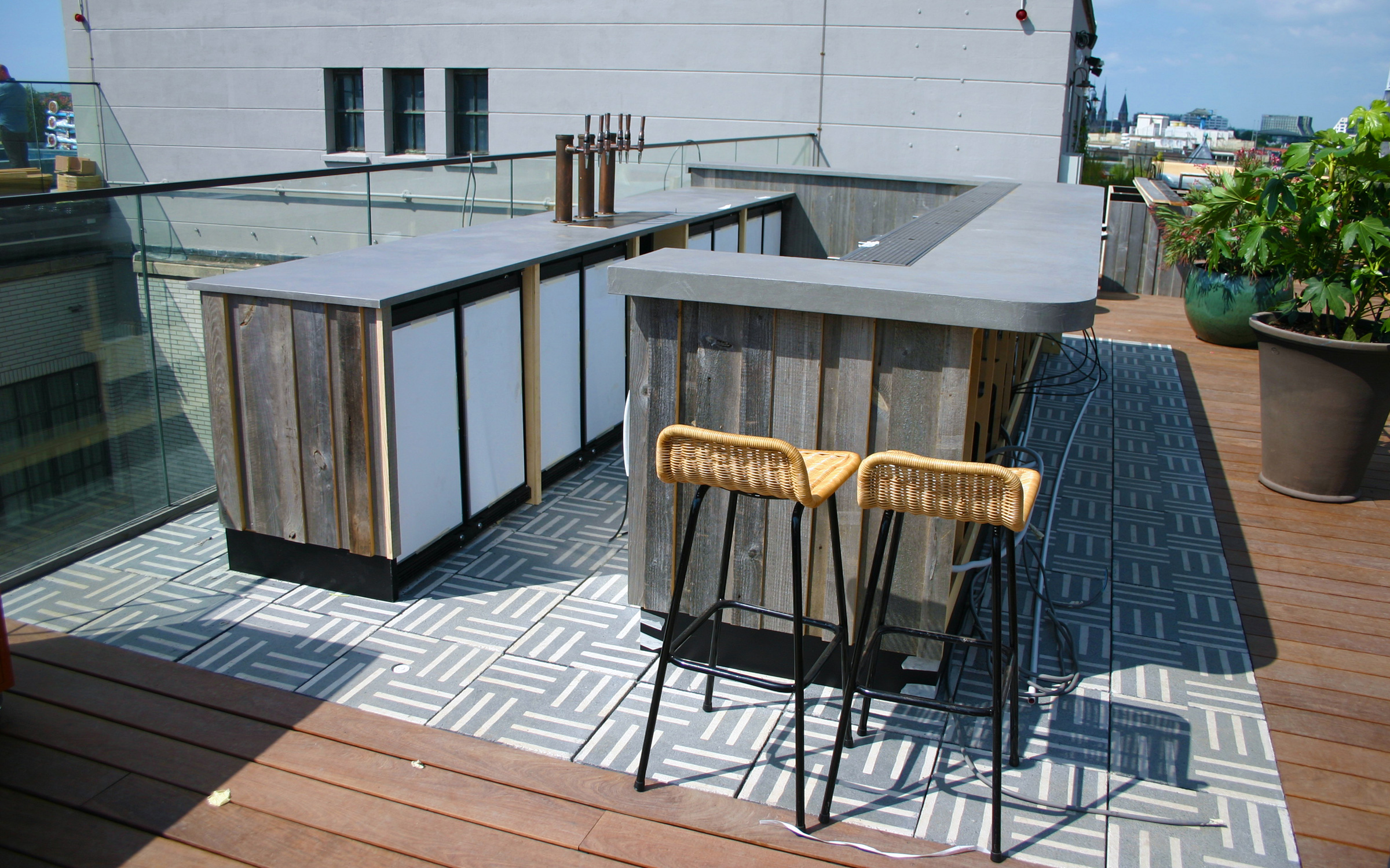 The bar is built on stylish slabs with a grey and white pattern. Roof garden with a bar